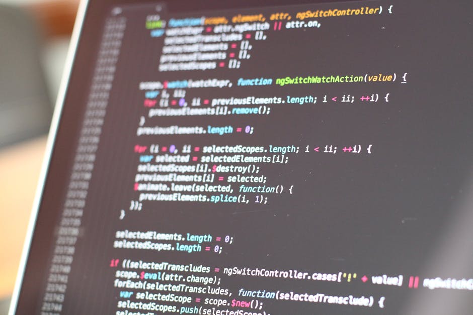A close-up view of a computer screen displaying colorful lines of code related to programming or web development, with the code written in various colors including pink, blue, green, and yellow on a d